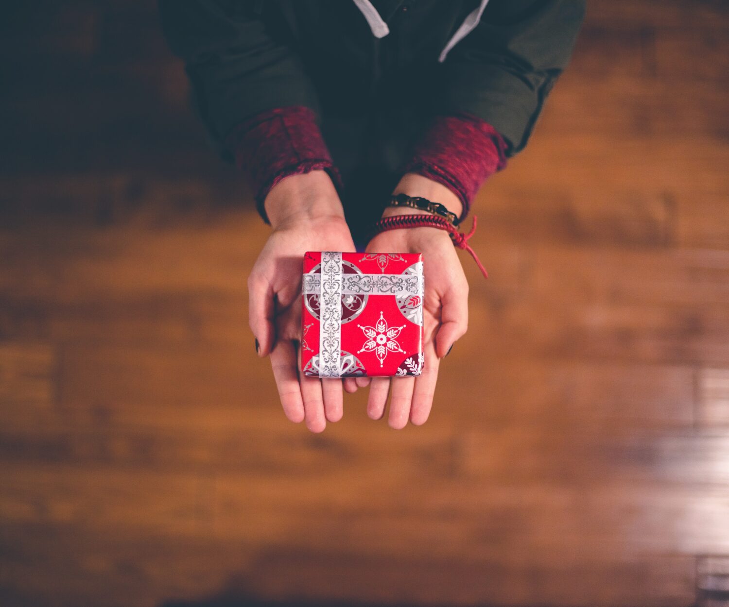 person holding red and white box