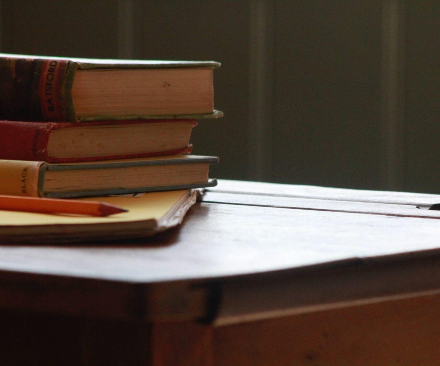 books and pencil on wooden table