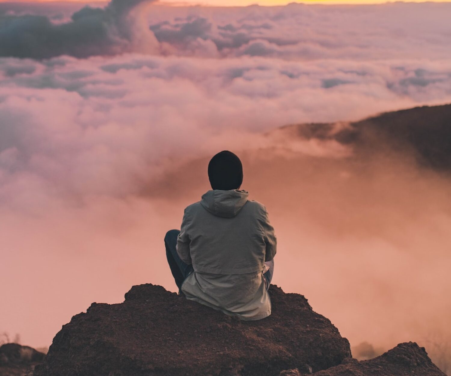 man sitting on cliff