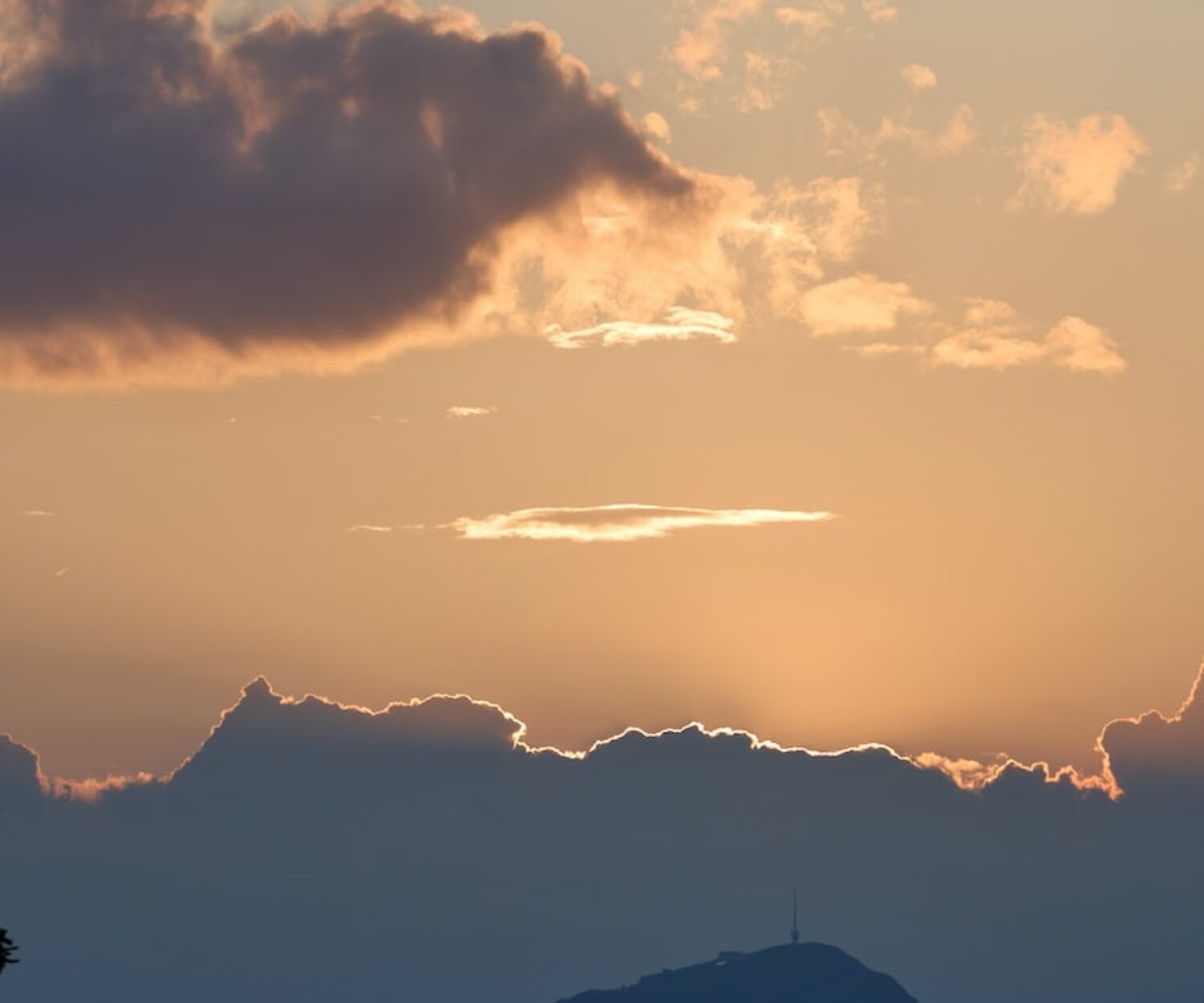 the sun is setting over a mountain range