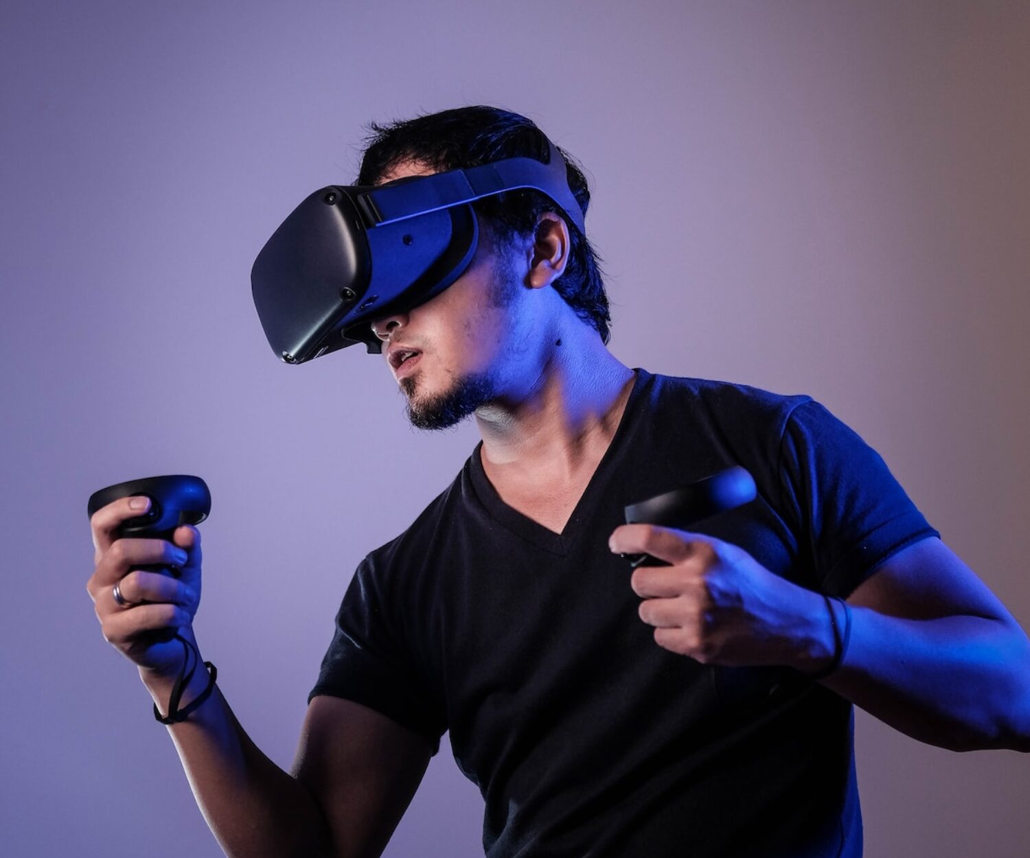 man in black crew neck t-shirt wearing black sunglasses holding black smartphone