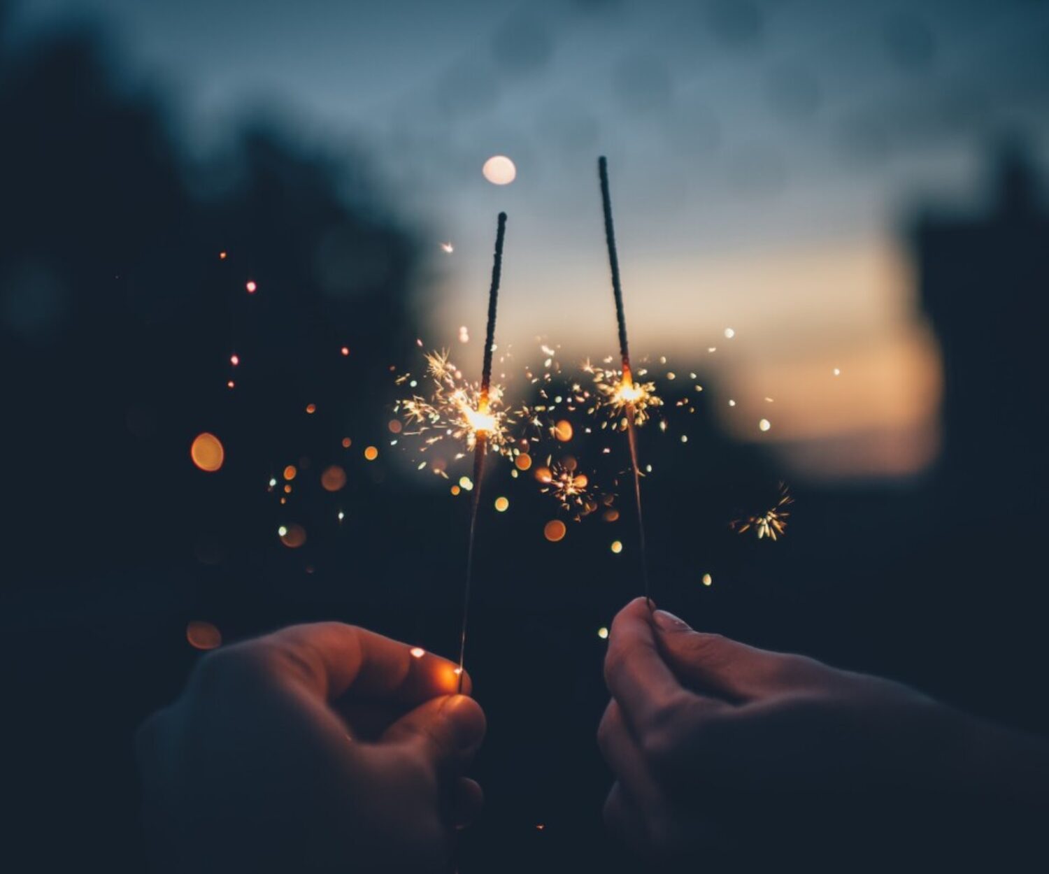 person holding fire cracker shallow focus photography