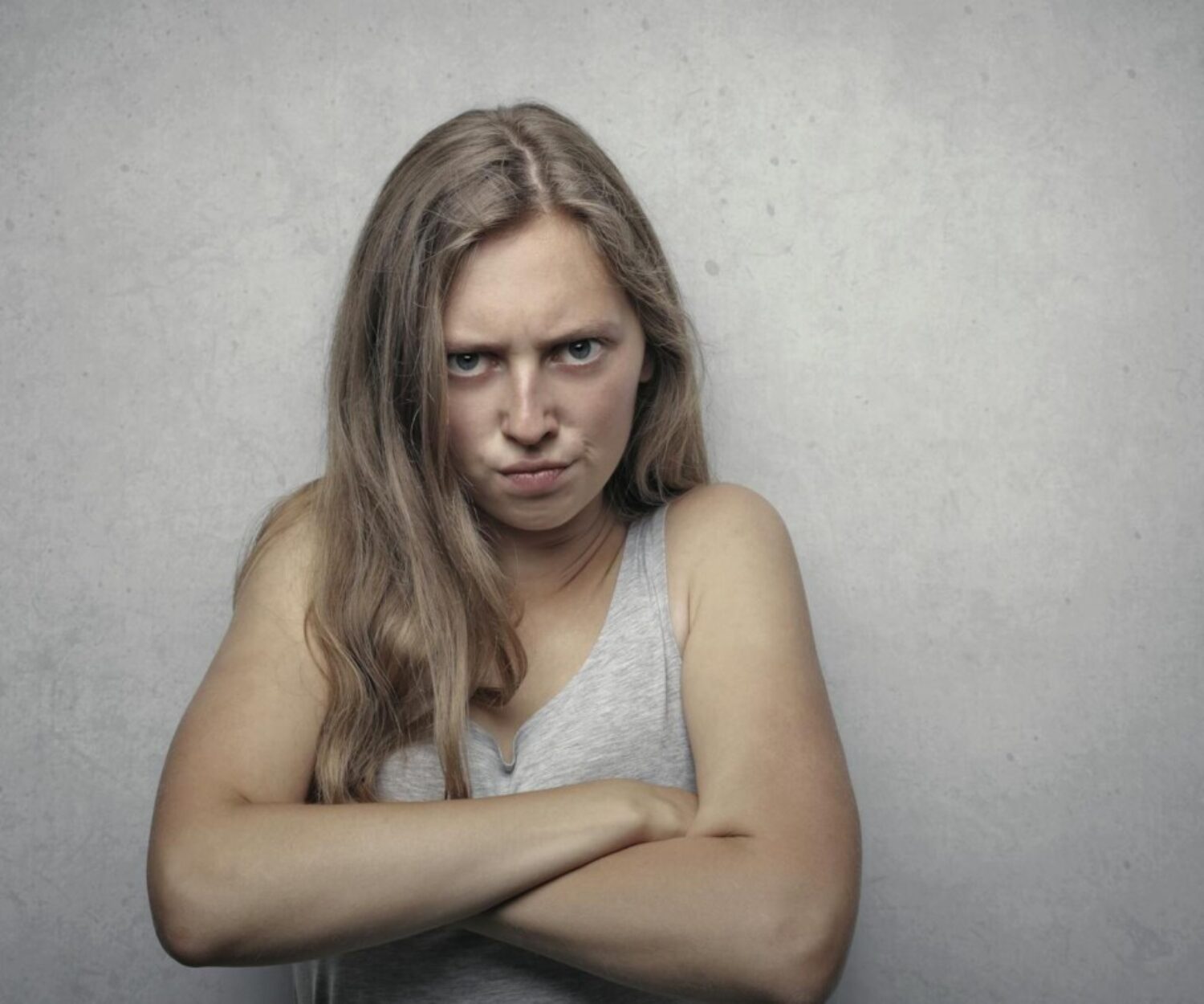 Woman in Gray Tank Top Looking Furious