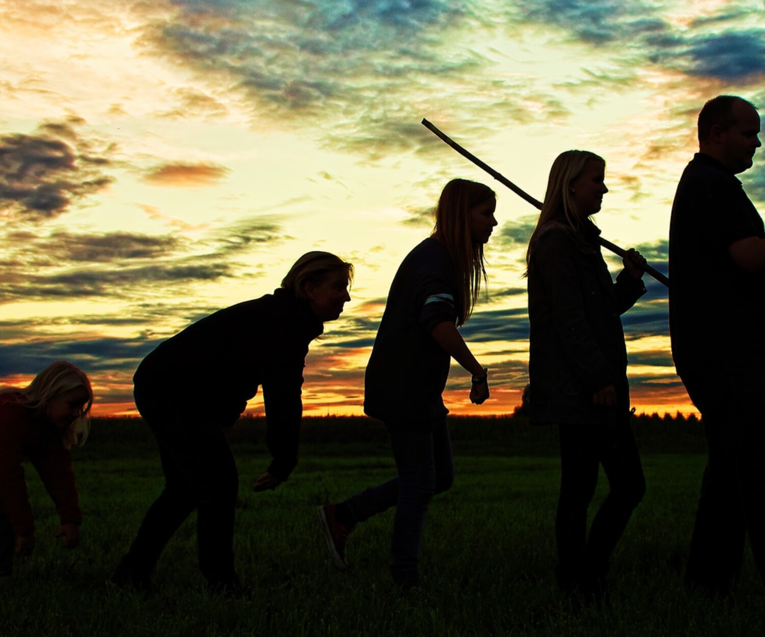 silhouette photo of group people standing on grass