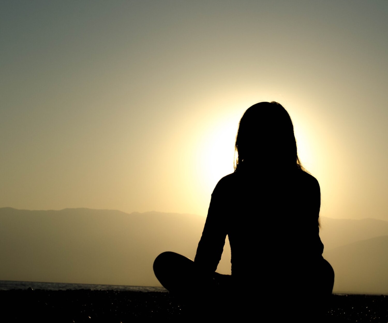 woman sitting on sand