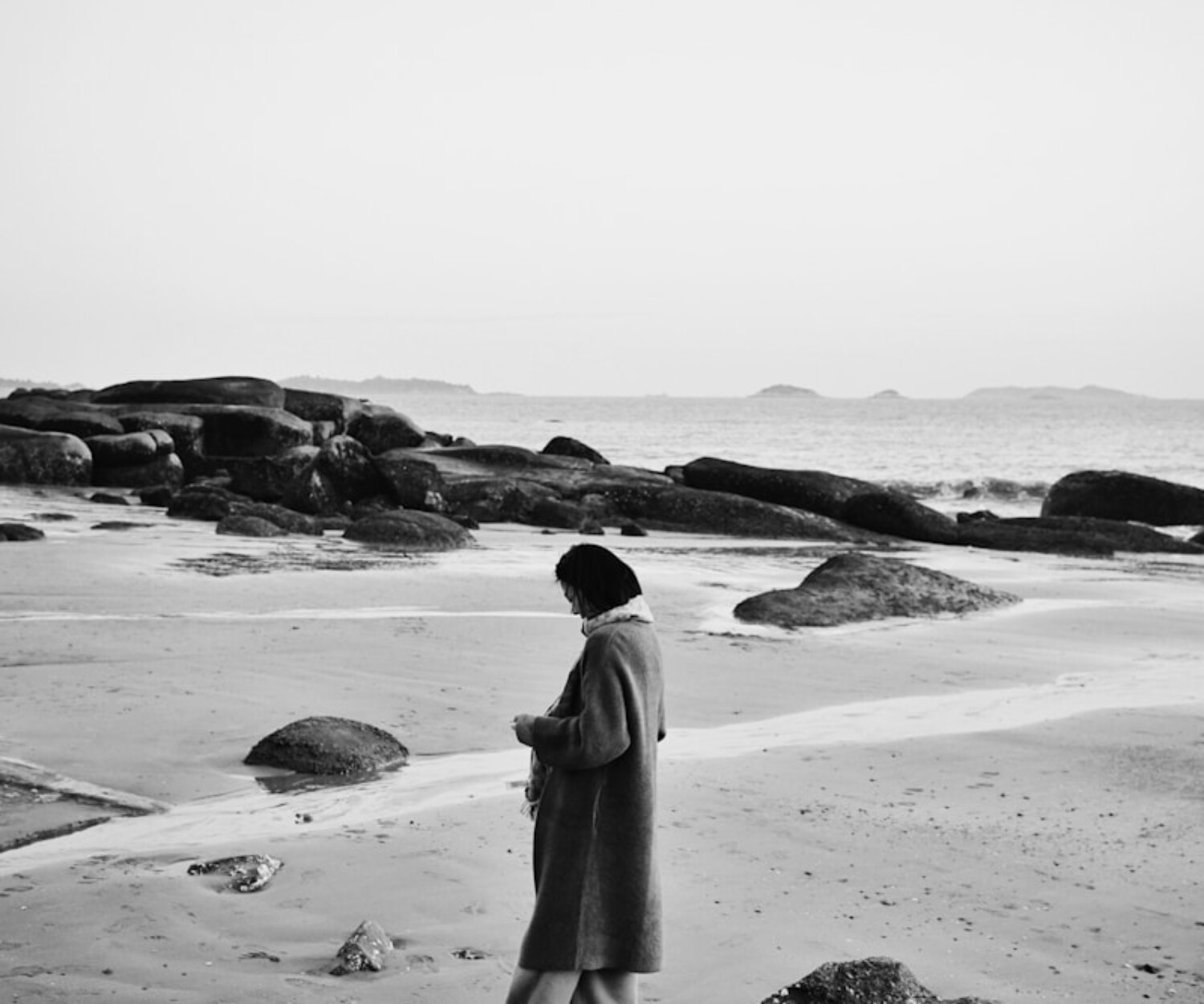 A person walks alone on the beach.