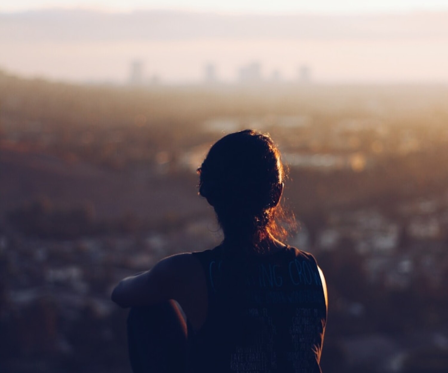woman sitting on brown rock during daytime