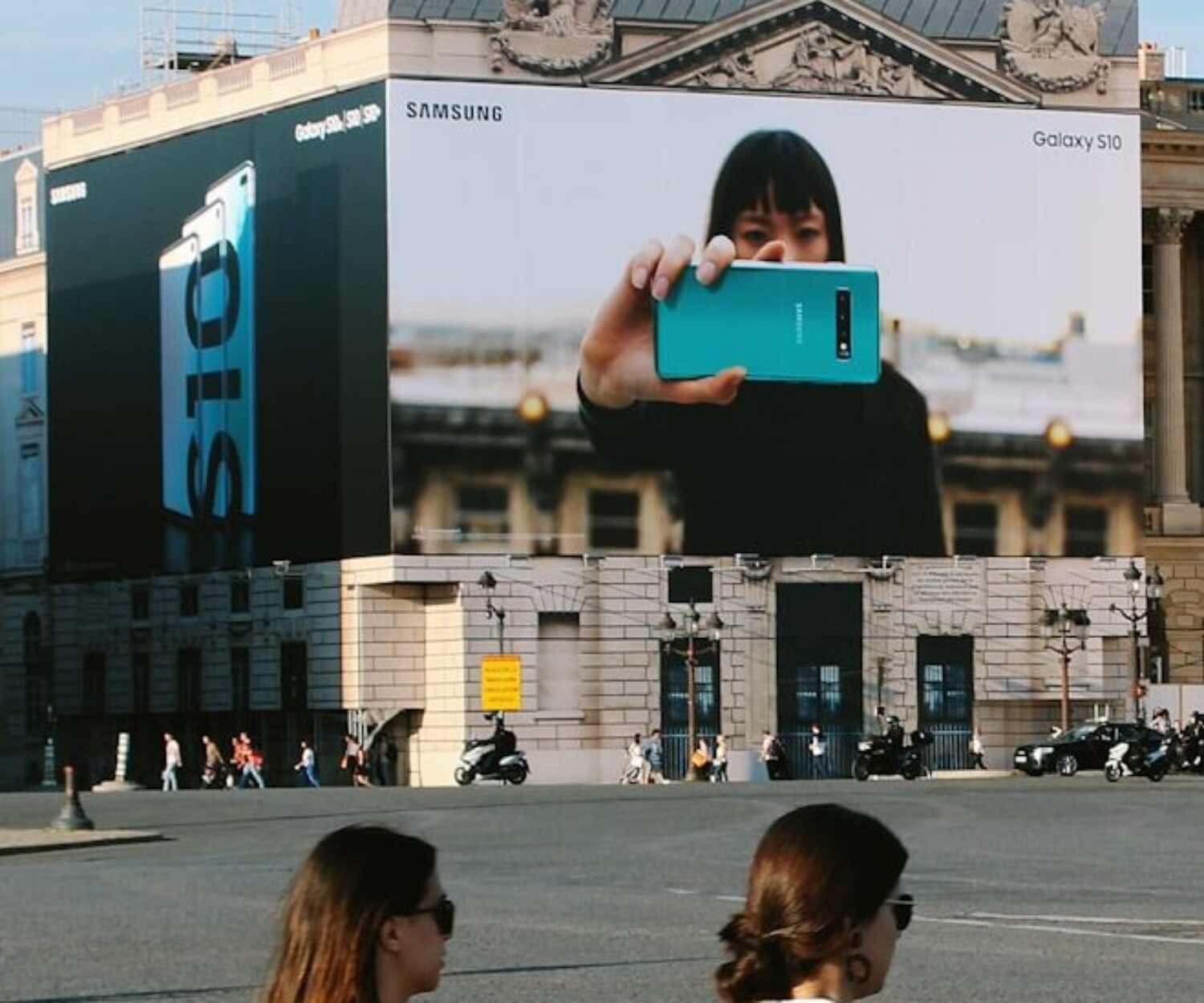 woman in white shirt holding blue tablet computer