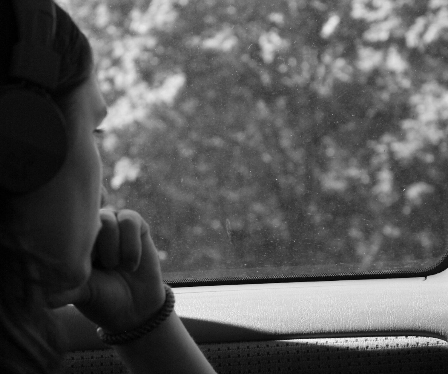 grayscale photo of woman inside car