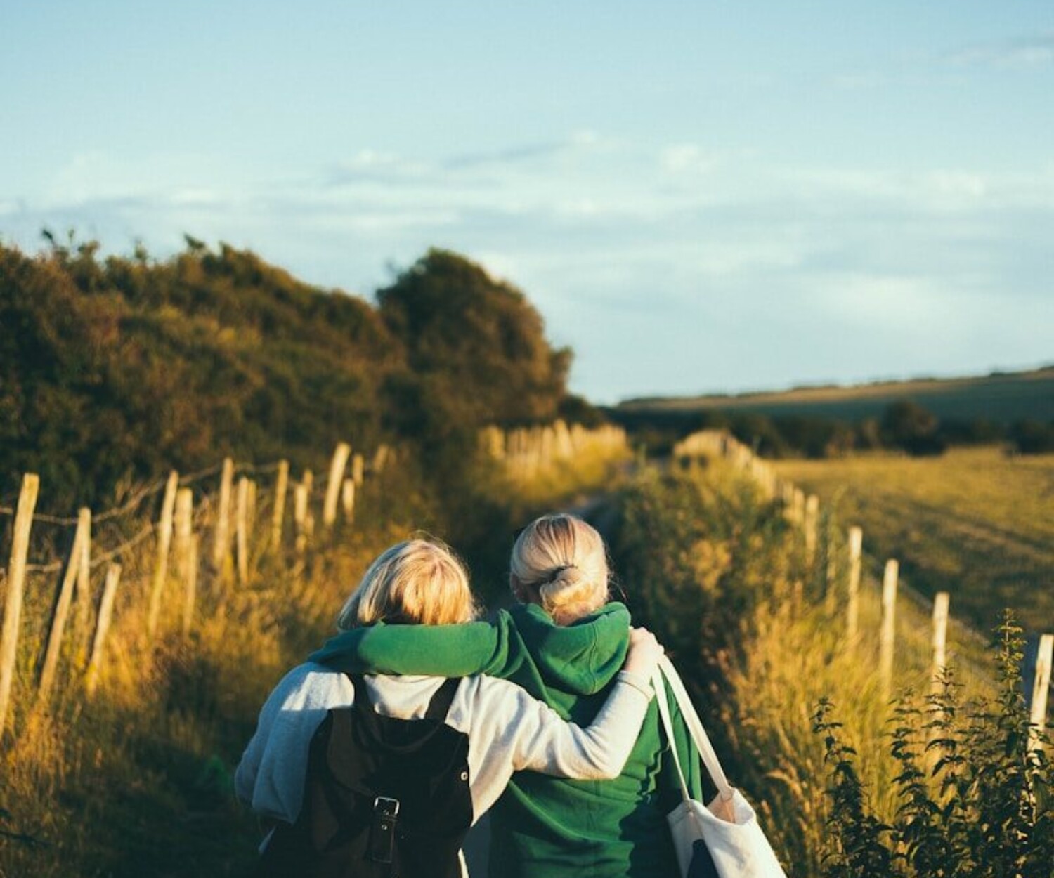 two women walking together outdoor during daytime