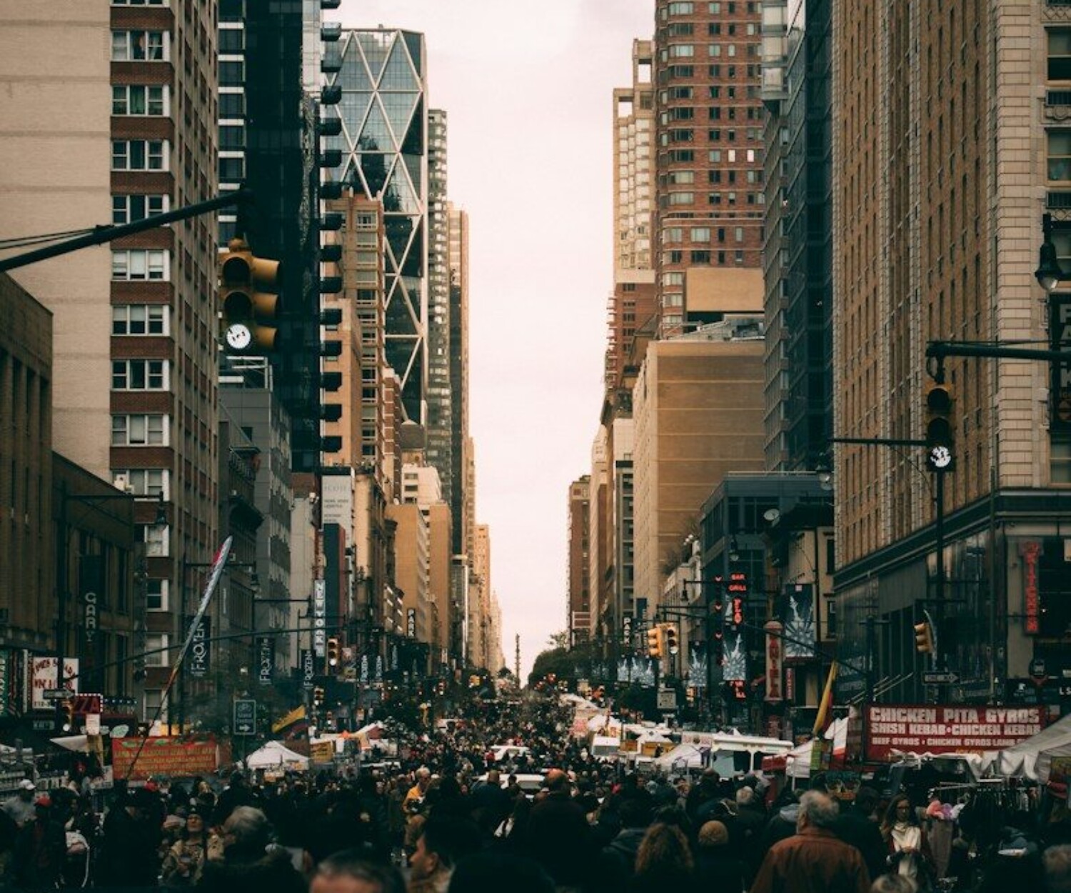 people on road between high-rise buildings
